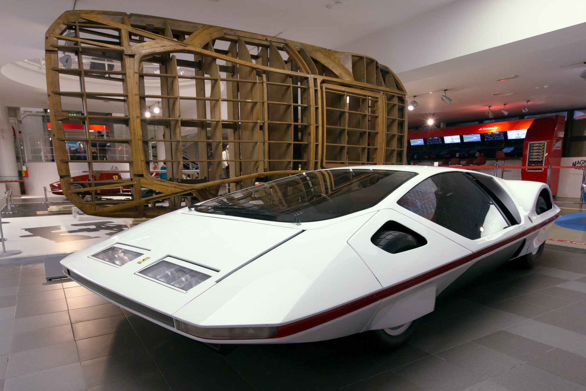 The 1970 Ferrari 512 S Modulo concept car on display in a museum, with the original wooden body buck used to shape it standing behind the finished car. Photo by Morio, own work, CC BY-SA 3.0.